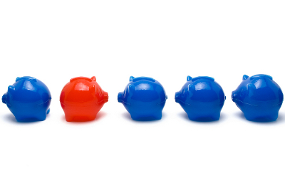 One red piggy bank going against the flow, showing the value of being an independent agent with SIMG insurance.